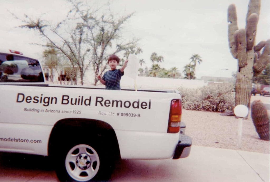 A man standing in front of a sign.